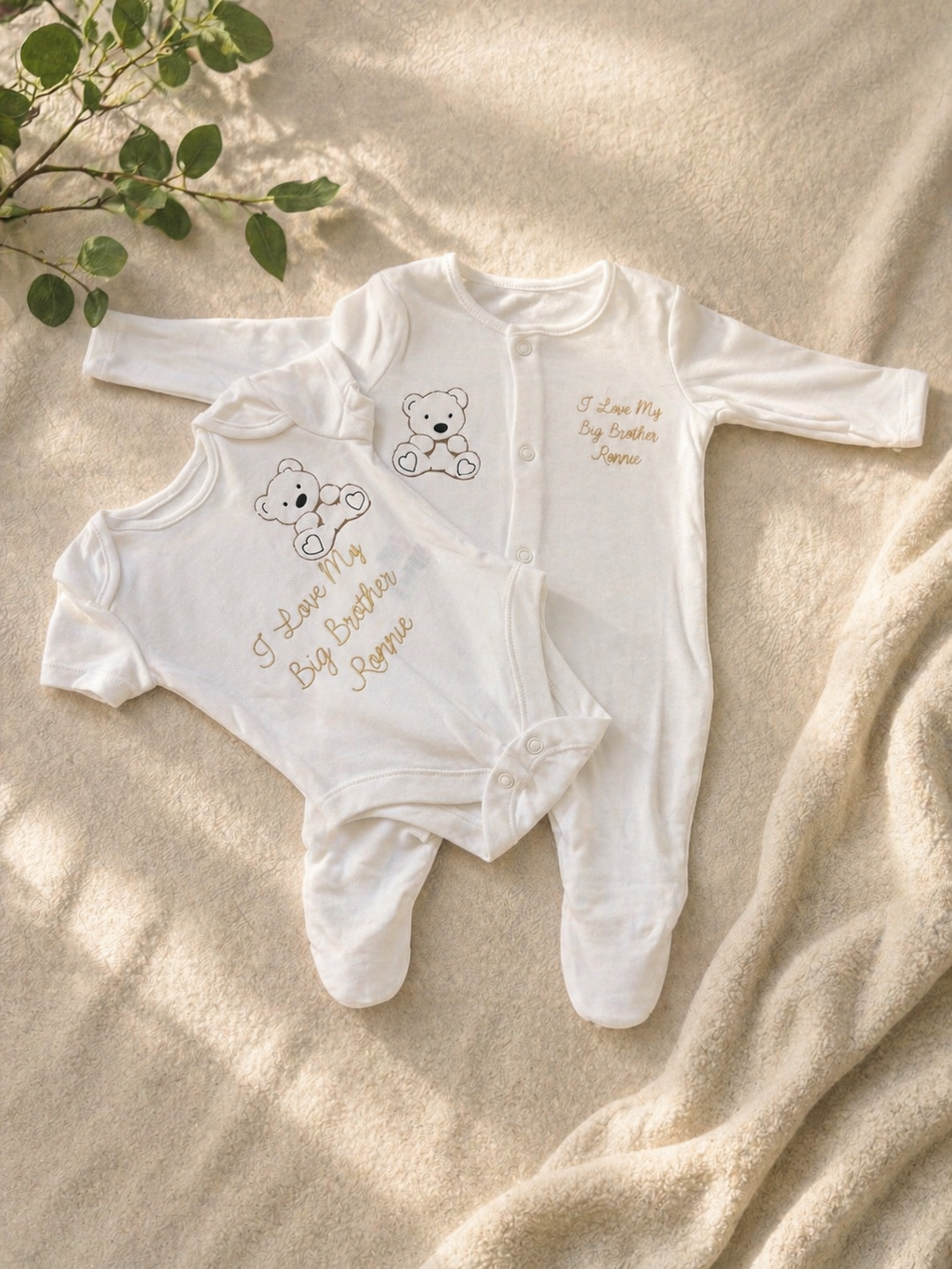 Personalised I Love My Big Brother baby bodysuit and sleepsuit set in white with gold teddy bear print and name Ronnie