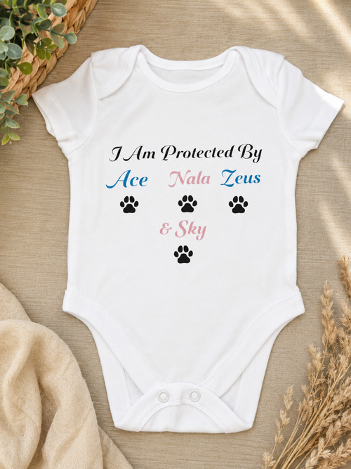 Personalised I Am Protected By baby bodysuit with pet names Ace, Nala, Zeus and Sky printed in blue and pink with paw prints on white cotton