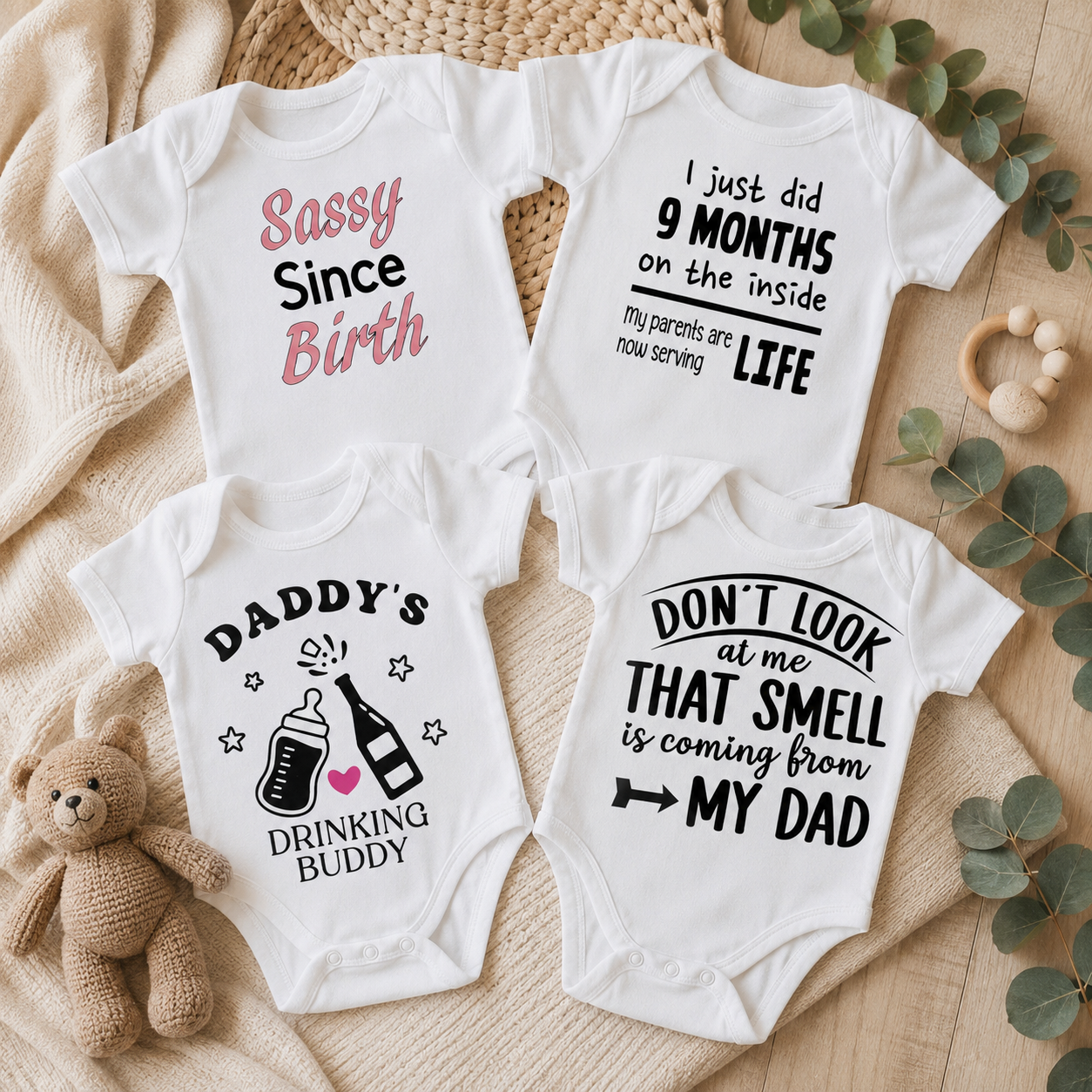 Four funny slogan baby bodysuits: Sassy Since Birth, I Just Did 9 Months on the Inside, Daddy's Drinking Buddy, and Don't Look at Me That Smell is Coming From My Dad