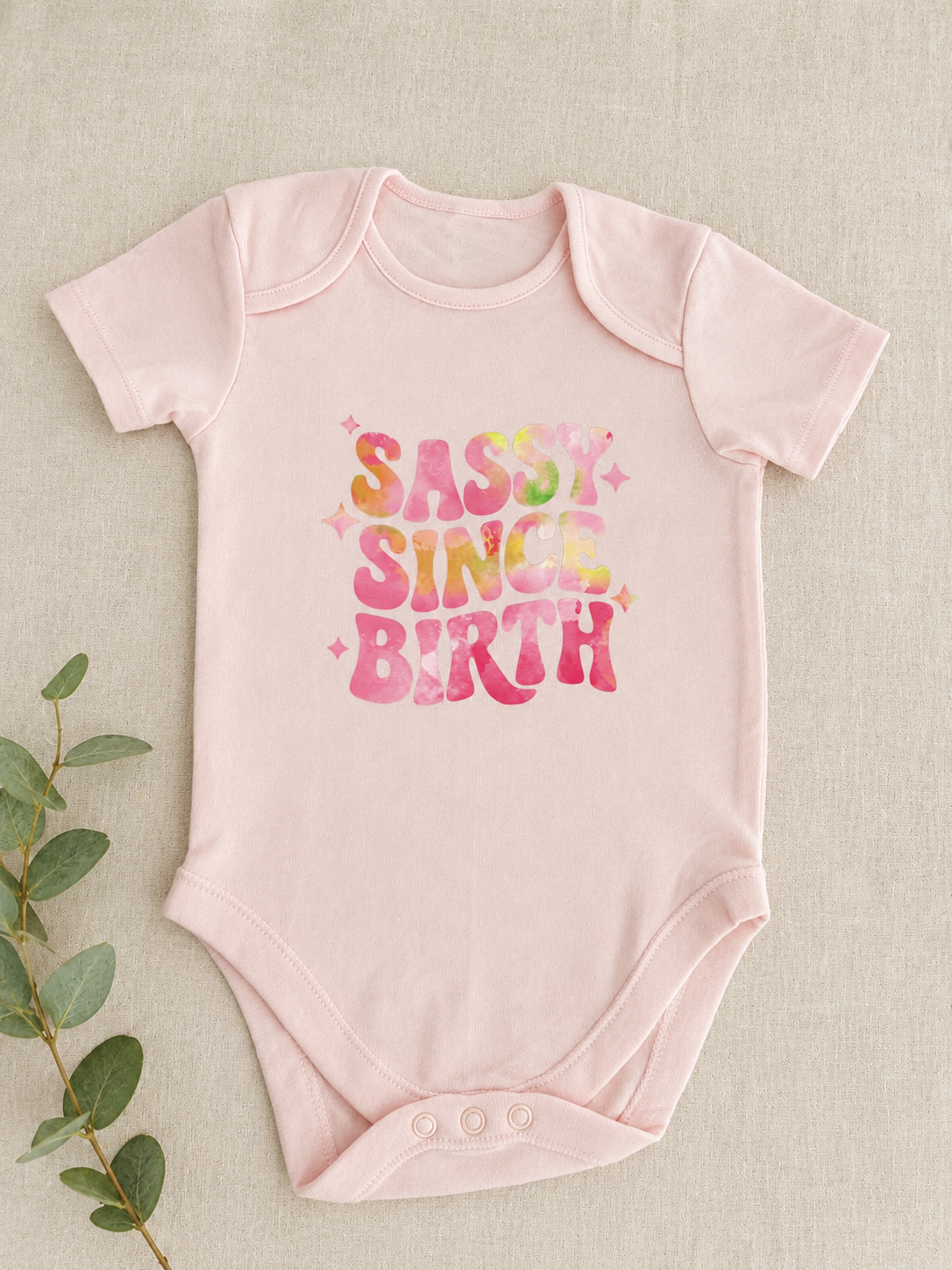 Sassy Since Birth blush pink baby bodysuit with tie-dye slogan print